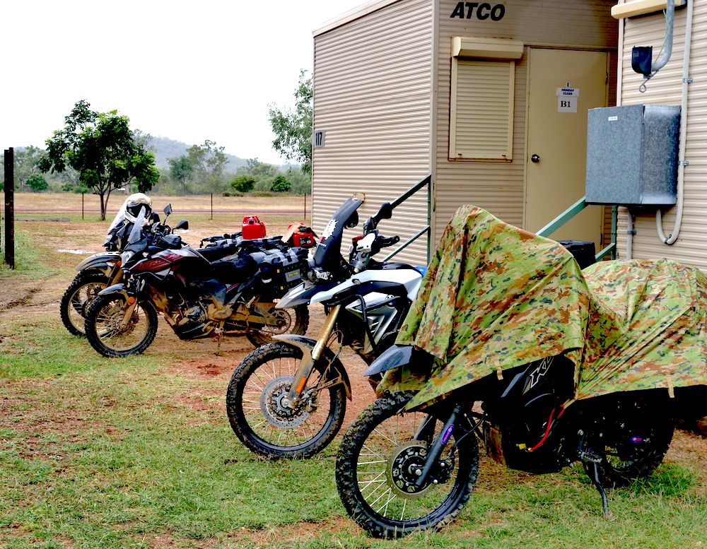 Adventure riders putting bikes away for the night